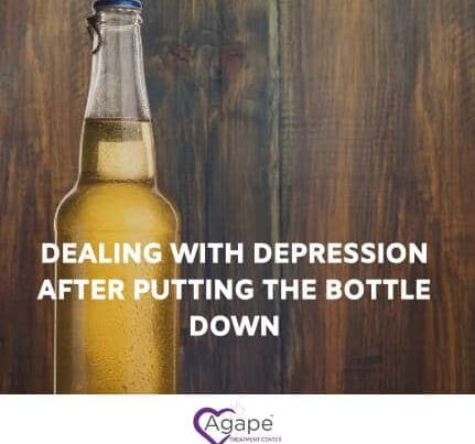 Beer bottle on wood, text Dealing with depression after putting the bottle down and Agape logo at bottom.