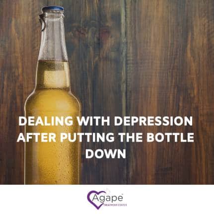 Beer bottle on wood, text Dealing with depression after putting the bottle down and Agape logo at bottom.