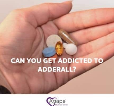 Hand holding various pills with text CAN YOU GET ADDICTED TO ADDERALL? and Agape Treatment Center logo.