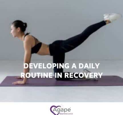Person in black workout outfit practicing yoga on mat.