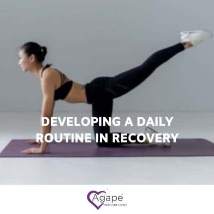 Person in black workout outfit practicing yoga on mat.