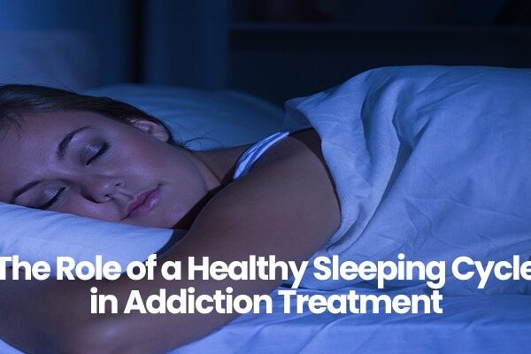 Person sleeping peacefully in bed with white sheets.