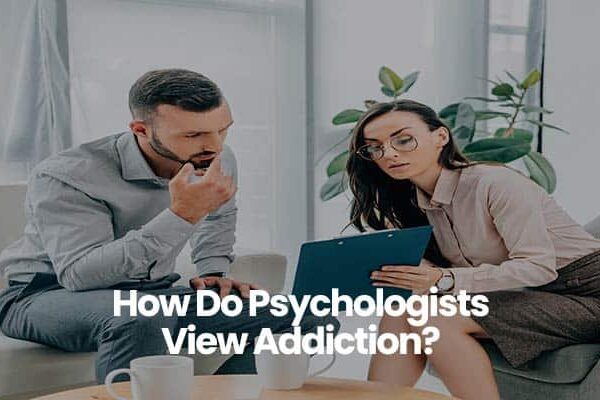 People discussing addiction in an office setting with clipboard.