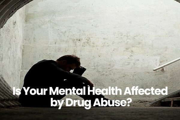 Silhouette of person sitting in tunnel with head in hands, text overlay Is Your Mental Health Affected by Drug Abuse?.