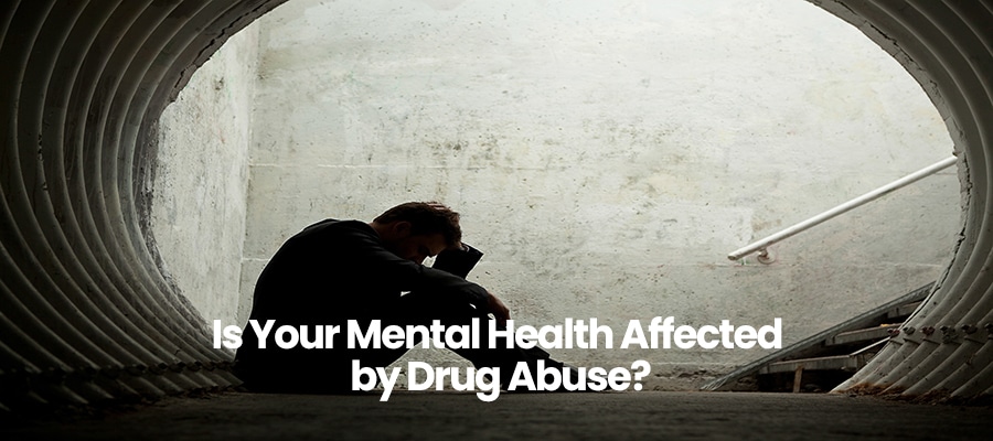 Silhouette of person sitting in tunnel with head in hands, text overlay Is Your Mental Health Affected by Drug Abuse?.