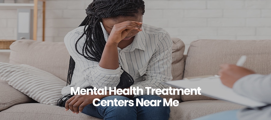 Person in striped shirt sitting on a couch, hand on forehead, text overlay reads Mental Health Treatment Centers Near Me.