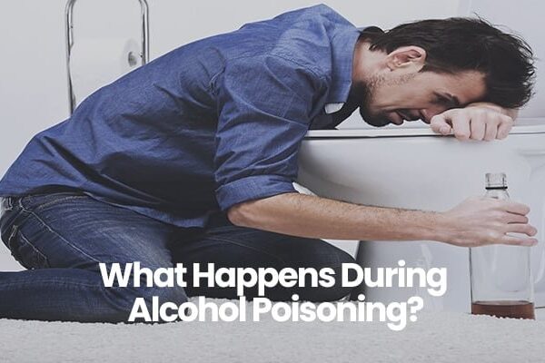 Person in denim shirt leaning over toilet holding bottle.