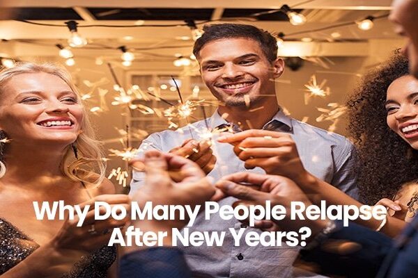 Group of people holding sparklers and smiling at party.