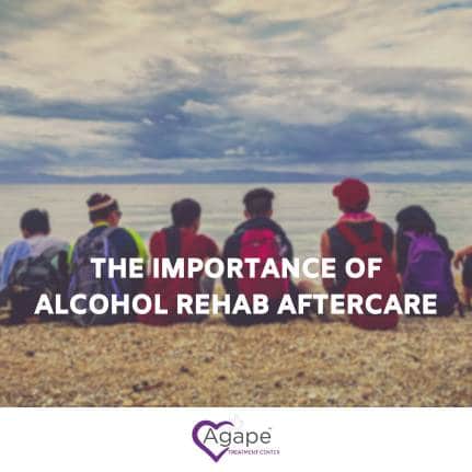 Group of people sitting on beach facing ocean with text 'The Importance of Alcohol Rehab Aftercare'