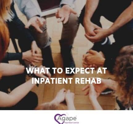 Group of people seated in a circle holding hands, text What to Expect at Inpatient Rehab, Agape logo below.