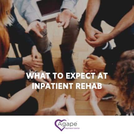 Group of people seated in a circle holding hands, text What to Expect at Inpatient Rehab, Agape logo below.