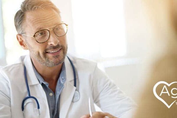 Person in white lab coat with stethoscope, listening attentively.