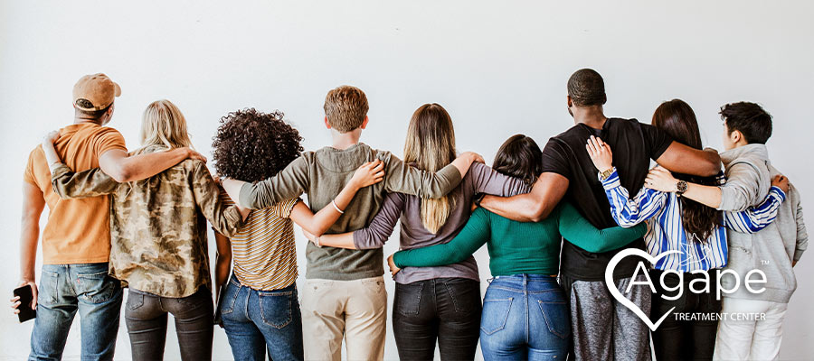 group of friends joined in arms showing support for one another