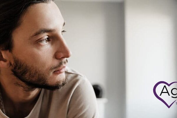 Person wearing a beige shirt looking to the side.