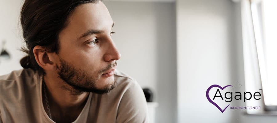 Person wearing a beige shirt looking to the side.