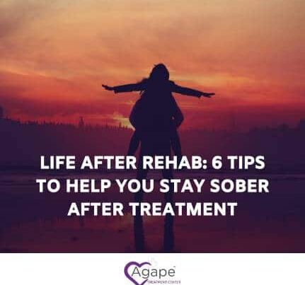 Silhouette of a person with arms outstretched at sunset, text overlay about staying sober after rehab.