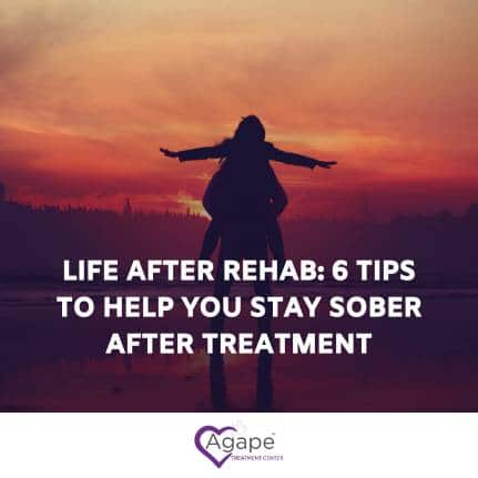 Silhouette of a person with arms outstretched at sunset, text overlay about staying sober after rehab.
