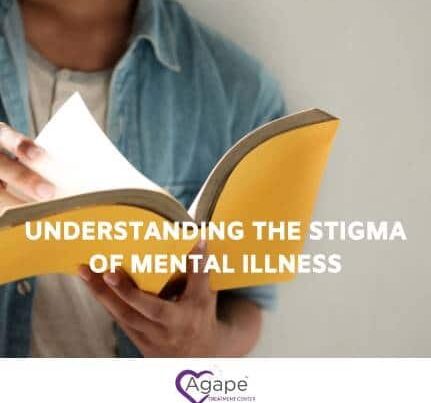 Person reading a book wearing a blue denim shirt, text Understanding the Stigma of Mental Illness.
