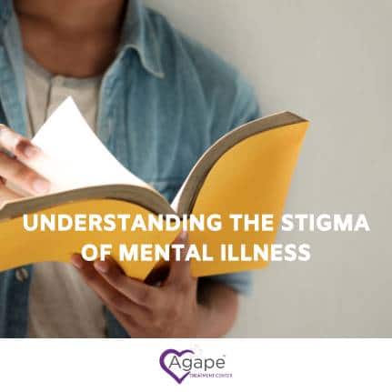 Person reading a book wearing a blue denim shirt, text Understanding the Stigma of Mental Illness.