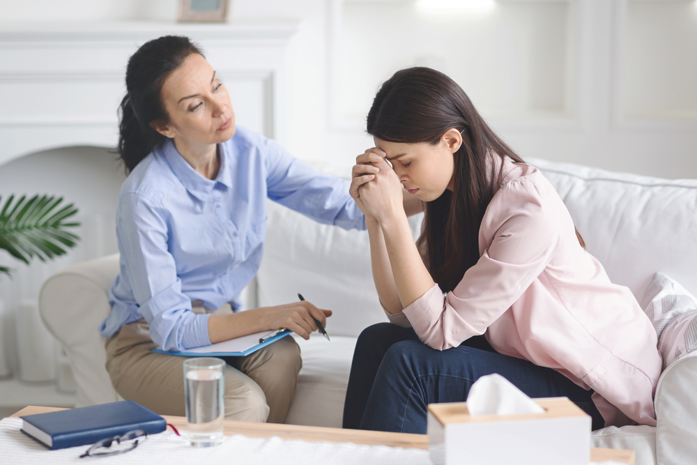 Therapist comforting woman in relapse prevention program