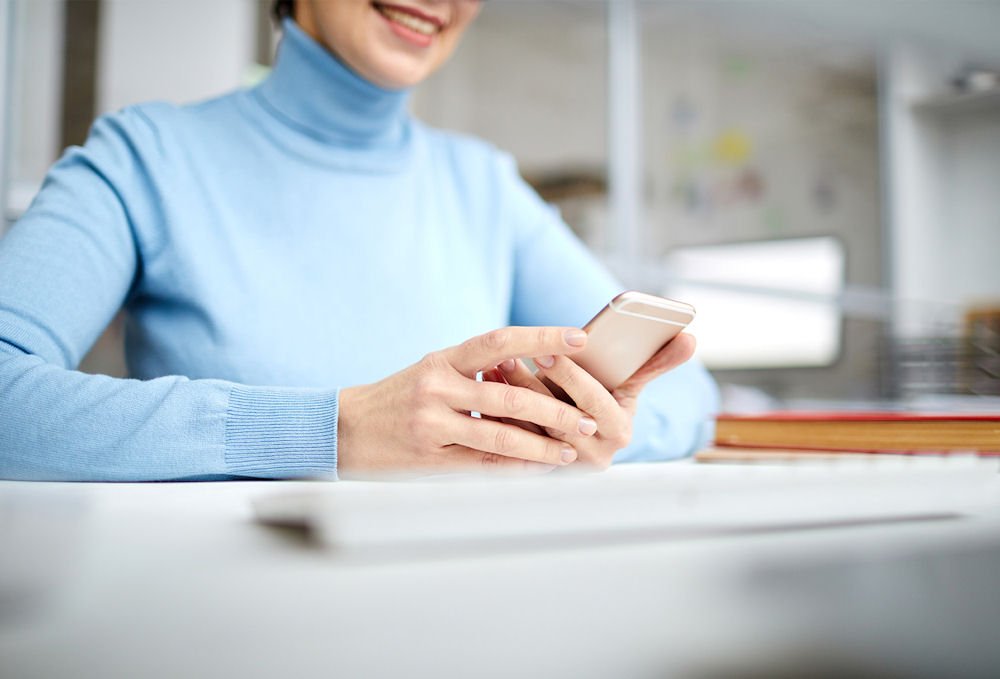 woman with her phone to contact rehab