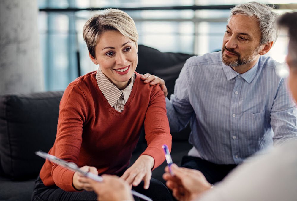 man and woman looking at therapy options