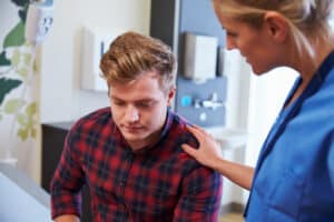 doctor talking to young male patient