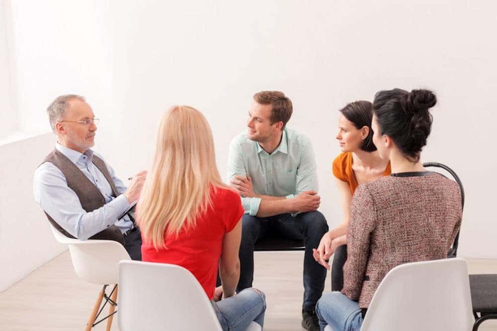 small group sitting in chairs for therapy session