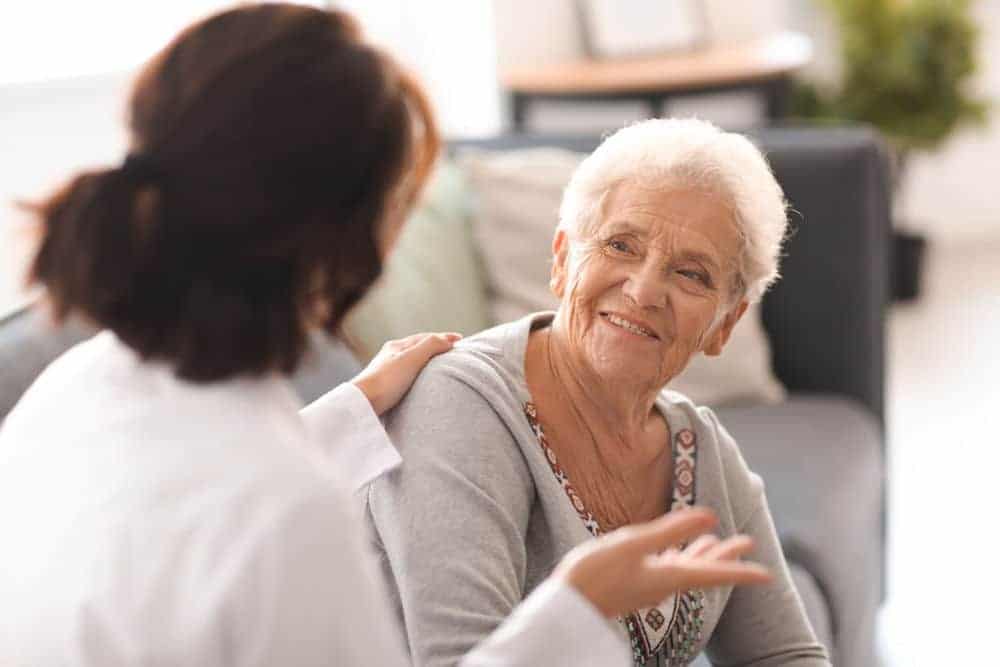 medical professional discussing treatment with elderly woman