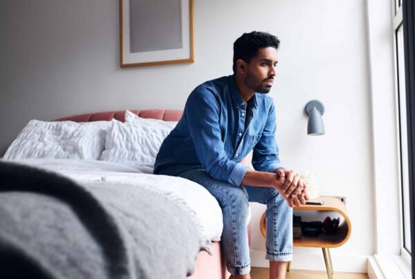 a man with ptsd sitting on his bed