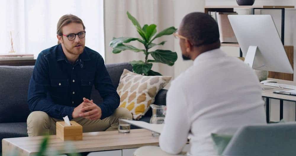 man sitting on couch for individual therapy session