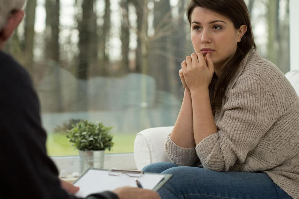 woman looking concerned in therapy