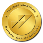 The Joint Commission gold seal of approval with geometric design.